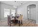 Dining room with modern light fixture and view into the hallway, kitchen, and bathroom at 3657 Daydream Pl, St Cloud, FL 34772