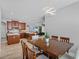 Dining room with modern light fixture and an open-concept view into the kitchen and living room at 3657 Daydream Pl, St Cloud, FL 34772