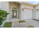 Close-up of a front door and one-car garage on a single-story house at 3657 Daydream Pl, St Cloud, FL 34772