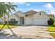 Well-kept single-story house featuring a two-car garage, arched entryway, and driveway at 3657 Daydream Pl, St Cloud, FL 34772