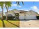 Charming one-story home with stucco facade, arched entryway, well-maintained landscaping, and a two-car garage at 3657 Daydream Pl, St Cloud, FL 34772