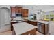 Bright kitchen with stainless steel appliances, white countertops, custom backsplash, and dark wood cabinetry at 3657 Daydream Pl, St Cloud, FL 34772
