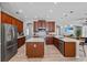 Spacious kitchen features wooden cabinets, stainless steel appliances, island, and modern countertops at 3657 Daydream Pl, St Cloud, FL 34772