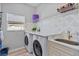 Laundry room with new washer and dryer, sink, and custom counter and backsplash at 3657 Daydream Pl, St Cloud, FL 34772