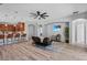 Open floor plan with view of the kitchen and living room area with wood flooring at 3657 Daydream Pl, St Cloud, FL 34772