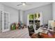 Home office featuring a large window, ceiling fan and wood-look floors at 3657 Daydream Pl, St Cloud, FL 34772