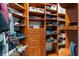Walk-in closet with custom wood shelving, drawers, and ample storage space at 3657 Daydream Pl, St Cloud, FL 34772