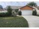 Charming single-Gathering home featuring a well-maintained lawn and a two-car garage at 738 Adidas Rd, Winter Springs, FL 32708