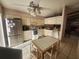 Well-lit kitchen with stainless steel appliances and dining area with tile flooring at 738 Adidas Rd, Winter Springs, FL 32708