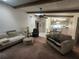 Inviting living room featuring beamed ceilings, fan, and ample seating with a dining area at 738 Adidas Rd, Winter Springs, FL 32708