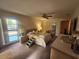 Cozy main bedroom with ceiling fan, carpet floors, and pool view from the large window at 738 Adidas Rd, Winter Springs, FL 32708