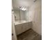 Bathroom with double sink vanity, modern fixtures, and white cabinets at 1142 Blarney St, Minneola, FL 34715
