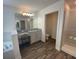 Beautiful bathroom offers a soaking tub, walk-in shower, wood flooring, and vanity at 1142 Blarney St, Minneola, FL 34715