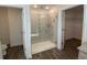 Bright bathroom features a glass shower, tiled walls, and an adjoining walk-in closet at 1142 Blarney St, Minneola, FL 34715