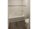 Bathroom featuring a white bathtub with decorative tile accents and a toilet at 1142 Blarney St, Minneola, FL 34715
