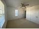 Bright bedroom featuring a ceiling fan, closet, and window with blinds at 1142 Blarney St, Minneola, FL 34715