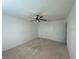 Bedroom features neutral carpet, ceiling fan, and closet at 1142 Blarney St, Minneola, FL 34715