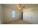Bedroom with ceiling fan, window, and double door closet at 1142 Blarney St, Minneola, FL 34715