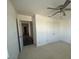 Well-lit bedroom with a ceiling fan, closet, and neutral carpeting at 1142 Blarney St, Minneola, FL 34715
