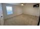 Bedroom with a window and a mounted TV at 1142 Blarney St, Minneola, FL 34715