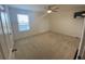 Bedroom features carpet, ceiling fan, and a window for natural light at 1142 Blarney St, Minneola, FL 34715
