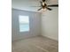 Bedroom features neutral colored carpet, ceiling fan, and plenty of natural light at 1142 Blarney St, Minneola, FL 34715