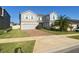 Two-story home with brick driveway, two-car garage, manicured lawn, and a mature palm tree at 1142 Blarney St, Minneola, FL 34715