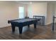 Large recreational game room featuring a pool table and sleek, modern furnishings at 1142 Blarney St, Minneola, FL 34715