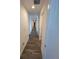 Hallway featuring hardwood floors and white walls at 1142 Blarney St, Minneola, FL 34715