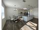 Bright kitchen with stainless appliances, large island, and adjacent dining area with a round glass table at 1142 Blarney St, Minneola, FL 34715