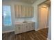 Bright kitchenette with granite countertops, wooden floors and cabinets next to a window at 1142 Blarney St, Minneola, FL 34715