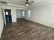Spacious living room features tray ceilings, ceiling fan, wood-look floors and an open plan at 1142 Blarney St, Minneola, FL 34715