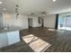 Open-concept living room and kitchen area with wood floors, modern lighting, and a sliding glass door at 1142 Blarney St, Minneola, FL 34715