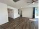 Open living area with stairs in the background, and sliding glass doors to the back at 1142 Blarney St, Minneola, FL 34715