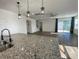 Open living area featuring a large island, sliding glass doors, and a ceiling fan at 1142 Blarney St, Minneola, FL 34715