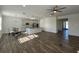 Open-concept space with hardwood floors flowing into the dining and kitchen area featuring an island and modern appliances at 1142 Blarney St, Minneola, FL 34715