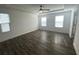 Bright main bedroom with wood floors and large windows at 1142 Blarney St, Minneola, FL 34715
