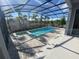 Screened in pool and spa with paved deck surrounded by palm trees for the ultimate private retreat at 1142 Blarney St, Minneola, FL 34715