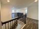 Staircase leading to a spacious upper-level game room with ample natural light at 1142 Blarney St, Minneola, FL 34715
