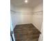 Walk-in closet with wood-look floors and wire rack shelving at 1142 Blarney St, Minneola, FL 34715