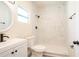 Modern bathroom featuring sleek vanity, new toilet, and a tiled walk-in shower with black fixtures at 1501 7Th Se St, Winter Haven, FL 33880