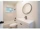 Bathroom featuring sleek vanity, toilet, and a tub and shower combo with white tile at 1501 7Th Se St, Winter Haven, FL 33880