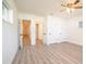 Large bedroom with wood-look flooring, a ceiling fan, closet, and several entryways at 1501 7Th Se St, Winter Haven, FL 33880
