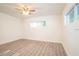 Light-filled bedroom with wood-look floors, ceiling fan, and large windows at 1501 7Th Se St, Winter Haven, FL 33880