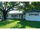 Charming one-story home with well-maintained lawn and mature trees providing shade at 1501 7Th Se St, Winter Haven, FL 33880