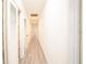 Well-lit hallway featuring gray floors and bright white trim at 1501 7Th Se St, Winter Haven, FL 33880