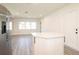 Bright kitchen view features updated countertops, gray flooring, and a stainless steel refrigerator at 1501 7Th Se St, Winter Haven, FL 33880