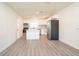 Spacious kitchen with stainless steel appliances, white cabinets and countertops, and durable wood-look floors at 1501 7Th Se St, Winter Haven, FL 33880