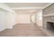 Open living room showcasing the brick fireplace and wood floors at 1501 7Th Se St, Winter Haven, FL 33880