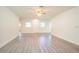 Open living area features light gray floors, natural light, and easy access to the front door at 1501 7Th Se St, Winter Haven, FL 33880